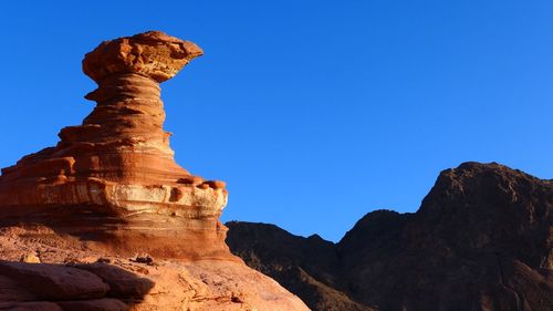 Low angle view of rock formations against sky