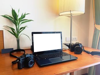 High angle view of laptop with camera on desk at home