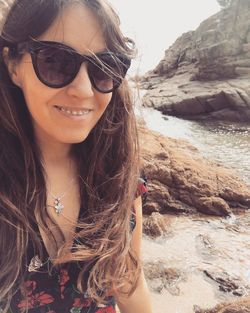 Portrait of young woman on sea shore