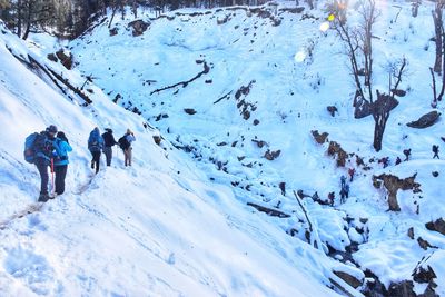 People walking on snow covered land