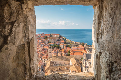 Panoramic view of sea and buildings against sky