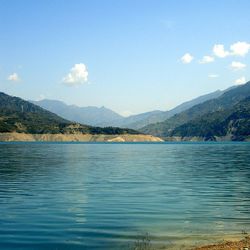 Scenic view of lake and mountains against sky