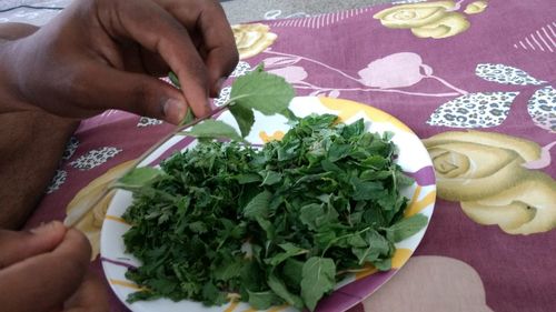 Close-up of man holding food on table