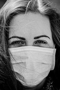 Close-up portrait of woman wearing mask outdoors