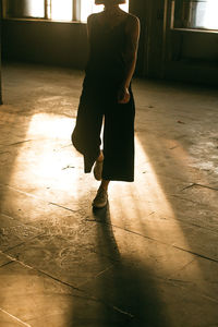 Low section of woman standing on tiled floor