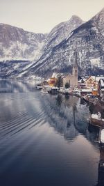 Scenic view of river by snowcapped mountains against sky