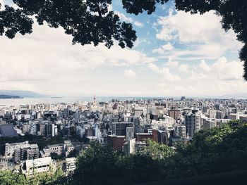 High angle view of trees and buildings against sky