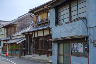 Old building by street in city