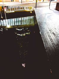 High angle view of illuminated footpath by buildings in city