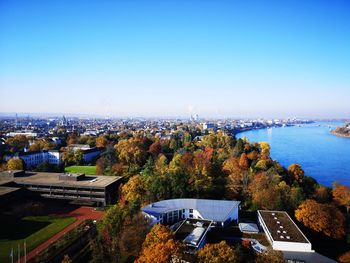 High angle view of buildings against clear blue sky