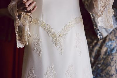 Midsection of bride wearing wedding dress