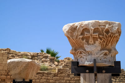 Low angle view of statue against blue sky