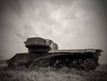 Abandoned truck on field against sky