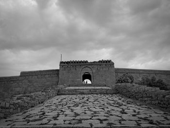 Historic building against cloudy sky