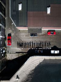 Shadows of people on road in city