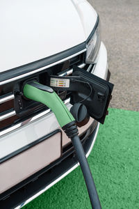 Detail of socket plugged into electric car