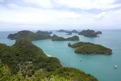 High angle view of sea and mountains against sky