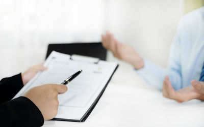 Midsection of businessman working on table