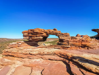 View of rock formation against clear blue sky