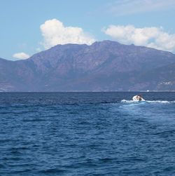 Scenic view of sea with mountains in background