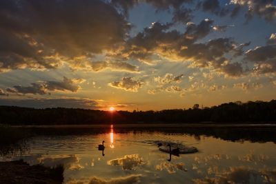 Scenic view of lake against sky during sunset