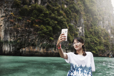 Teenage girl taking selfie in canyon