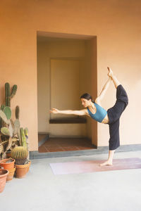 Woman doing stretching exercise at home