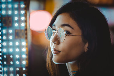 Close-up portrait of young woman looking away