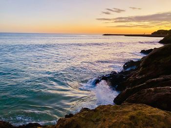 Scenic view of sea against sky during sunset