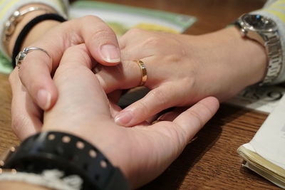 Midsection of couple holding hands