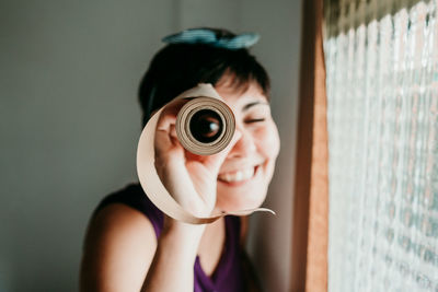 Portrait of woman holding camera