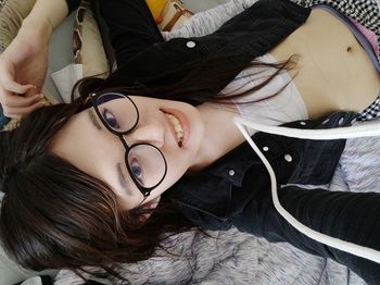 Portrait of woman lying down on bed