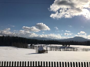 Scenic view of snow covered landscape against sky