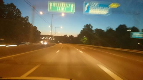 Road passing through landscape at night