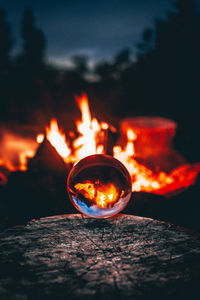 Close-up of lit candle against blurred background