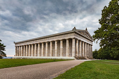 Low angle view of historical building against cloudy sky