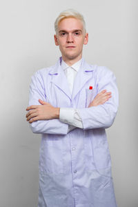 Portrait of doctor standing acting white background