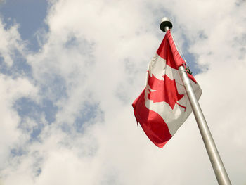 Low angle view of canadian flag against sky