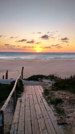 Scenic view of beach against sky during sunset