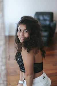 Portrait of smiling young woman at home