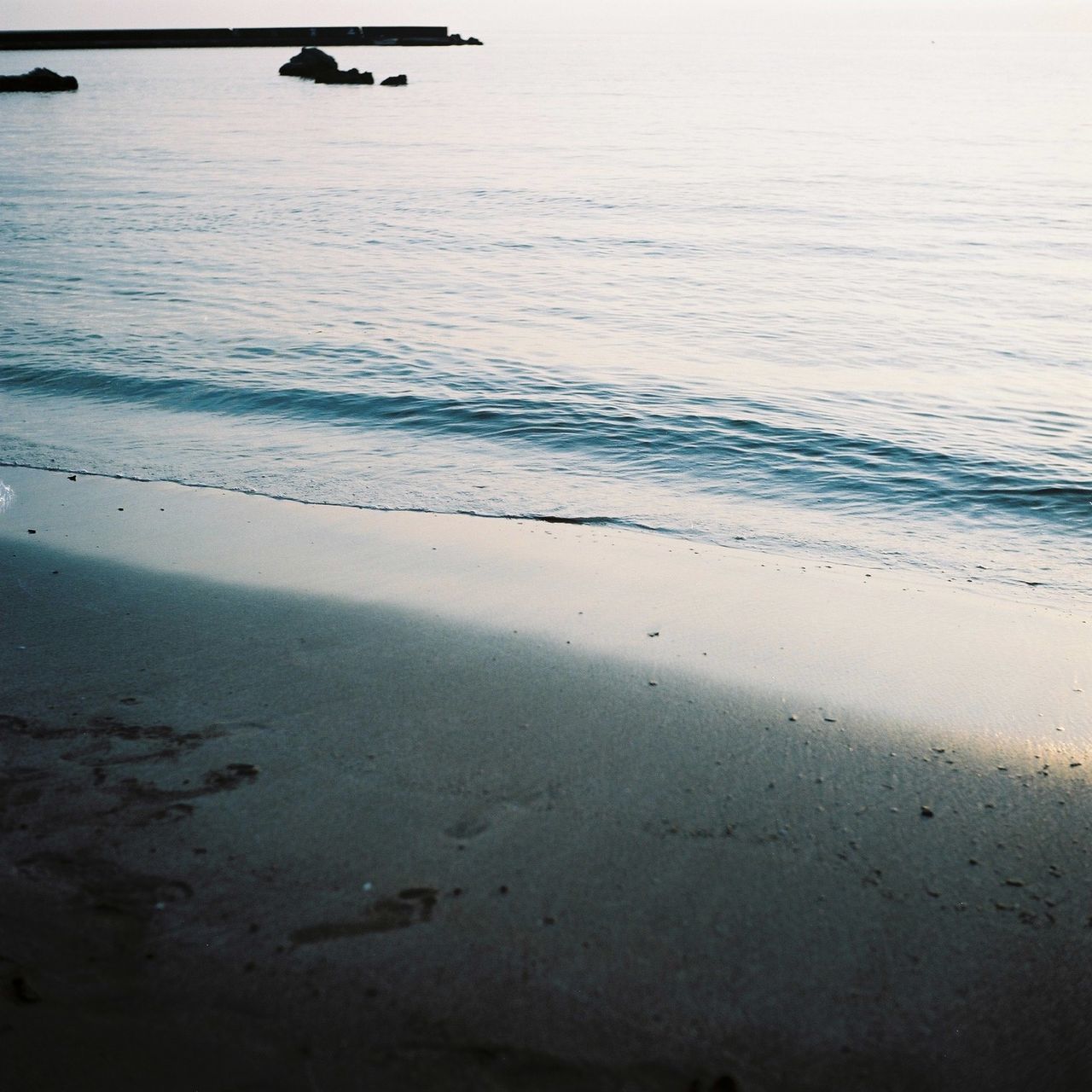 CLOSE-UP OF AIRPLANE WING ON BEACH