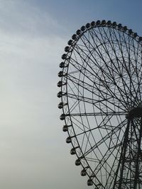 Low angle view of ferris wheel against sky