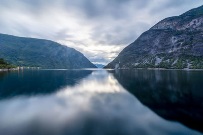 View under cloudy skies on a fjord in norway in the background passage to the sea between mountains