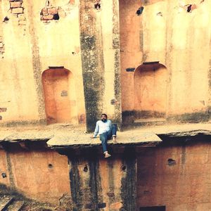 Low section of people standing on wet window