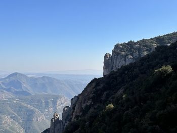 Scenic view of mountains against clear blue sky