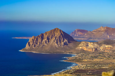 Scenic view of sea and mountains against sky