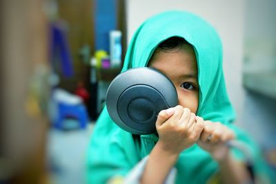 Portrait of boy holding camera