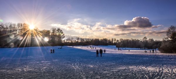 Scenic view of snowy field against sky during winter