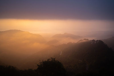 Scenic view of silhouette mountains against sky during sunset