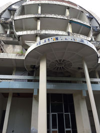 Low angle view of ferris wheel against building